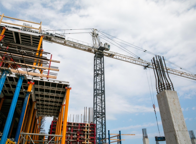 Construction site at West Lincoln Memorial Hospital with a tower crane and concrete structures.